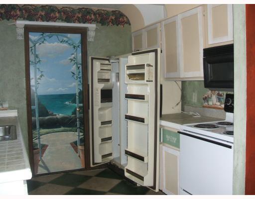 2864 Southwest Seaside Road Port St. Lucie, FL 34953 - Photo 5 of 5 a kitchen with stainless steel appliances kitchen island granite countertop a refrigerator and a stove