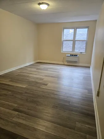 a view of room with wooden floor and window