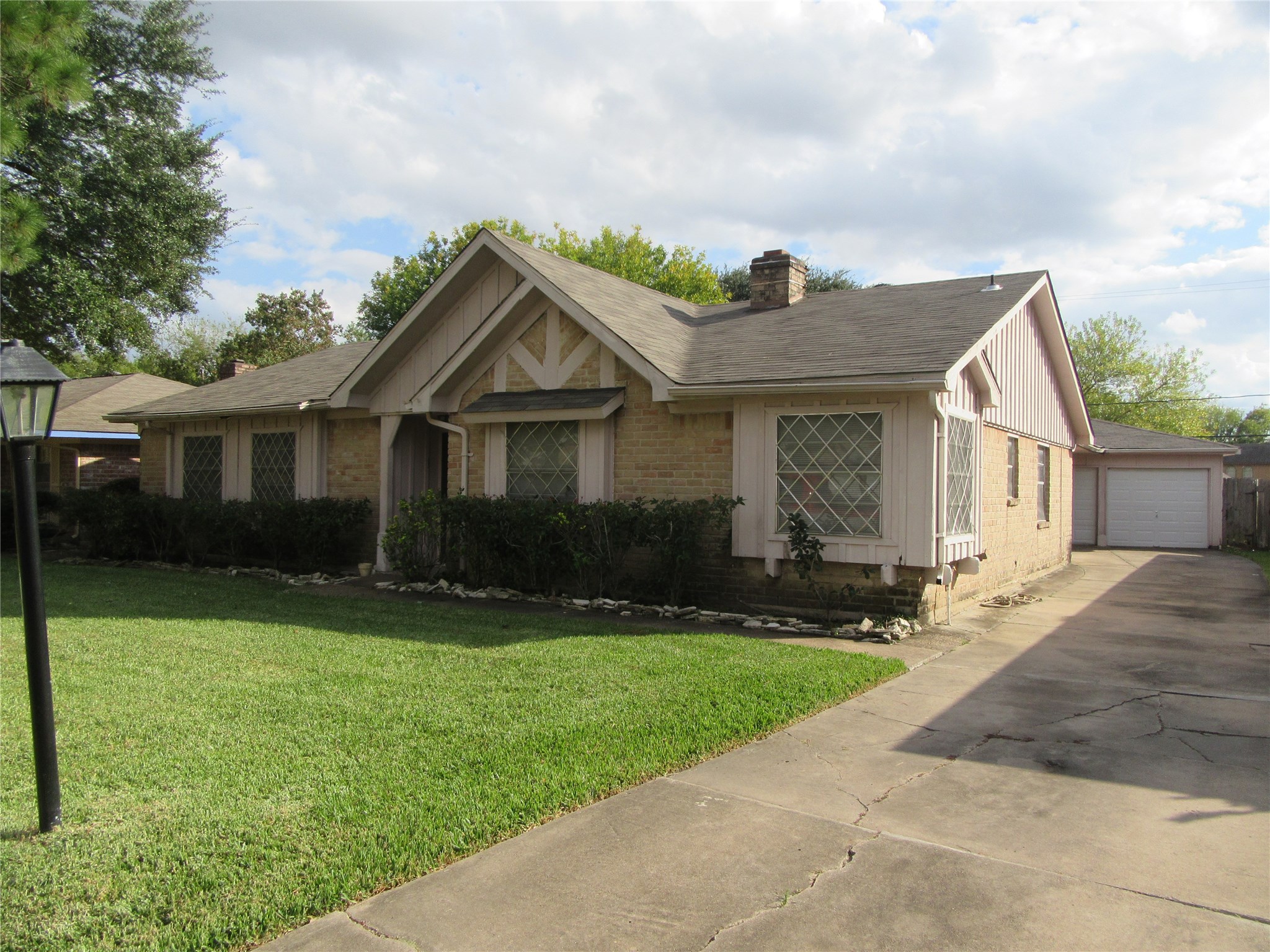 12215 Pompano Lane Houston, TX 77072 - Photo 2 of 15 a front view of a house with a yard and garage