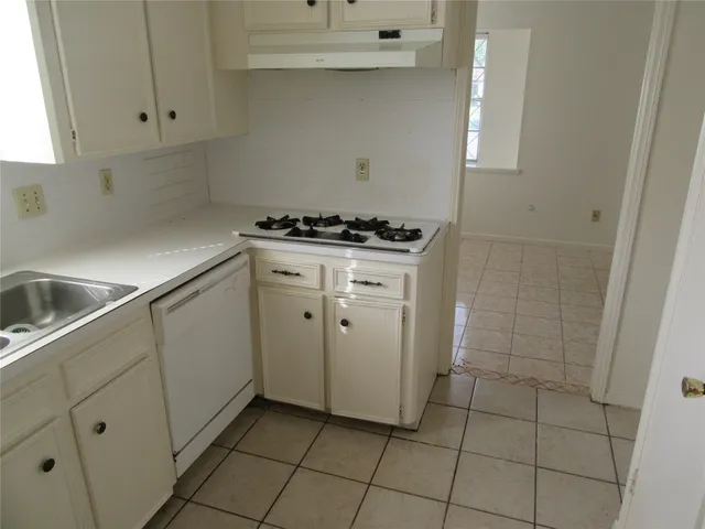 a kitchen with cabinets and appliances