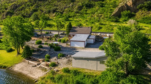 an aerial view of a house with a yard and lake view