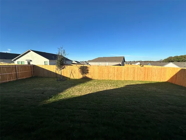 a front view of a house with yard and garage