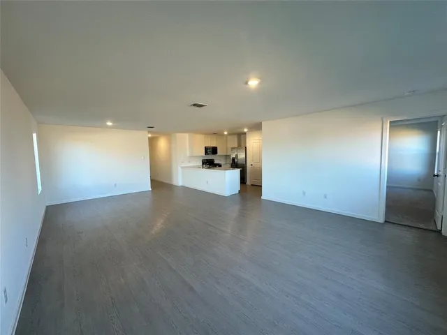 a view of a livingroom with furniture and an empty room