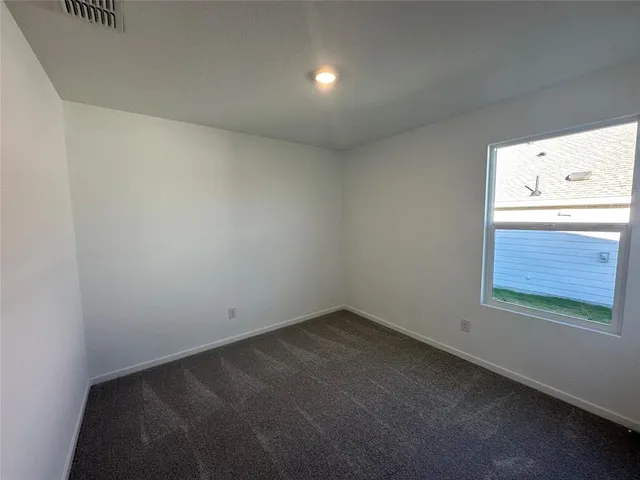 a view of an empty room and a window