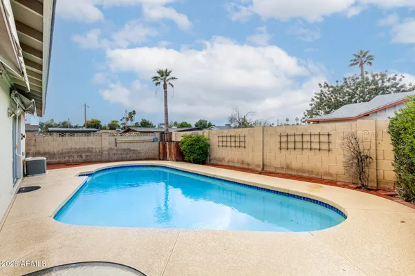 a view of a swimming pool with a lounge chairs