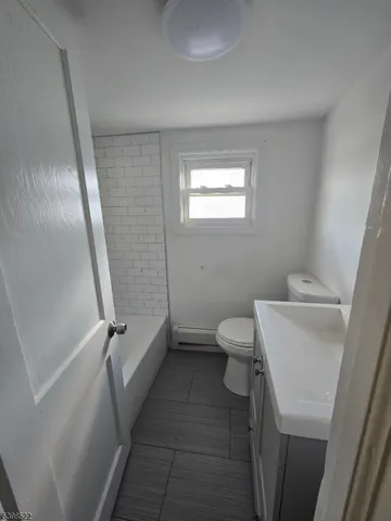 a bathroom with a toilet sink and tub