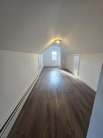 a view of wooden floor and windows in a room