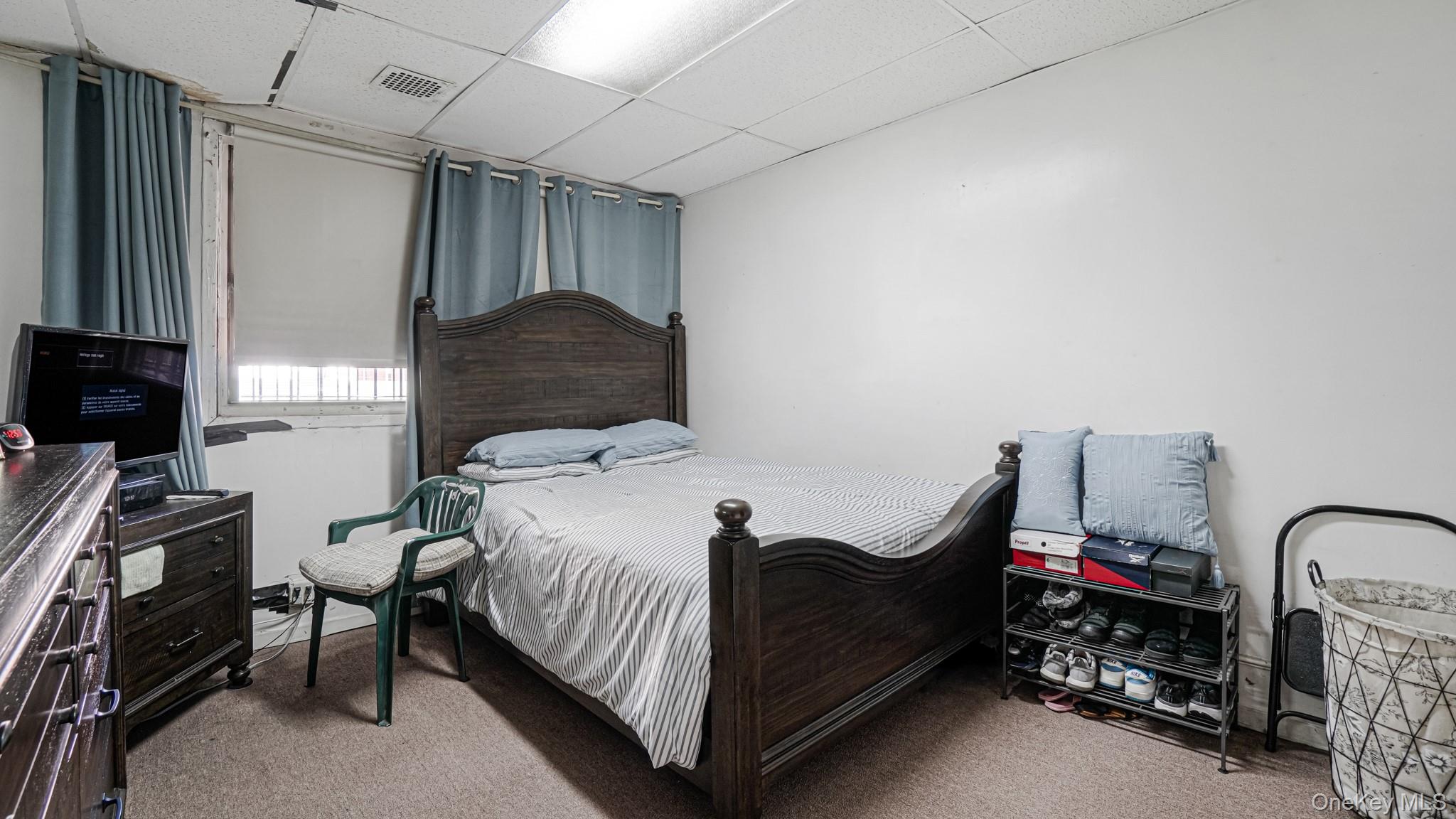 1270 Rosedale Avenue Bronx, NY 10472 - Photo 14 of 19 a bedroom with a bed and a chandelier