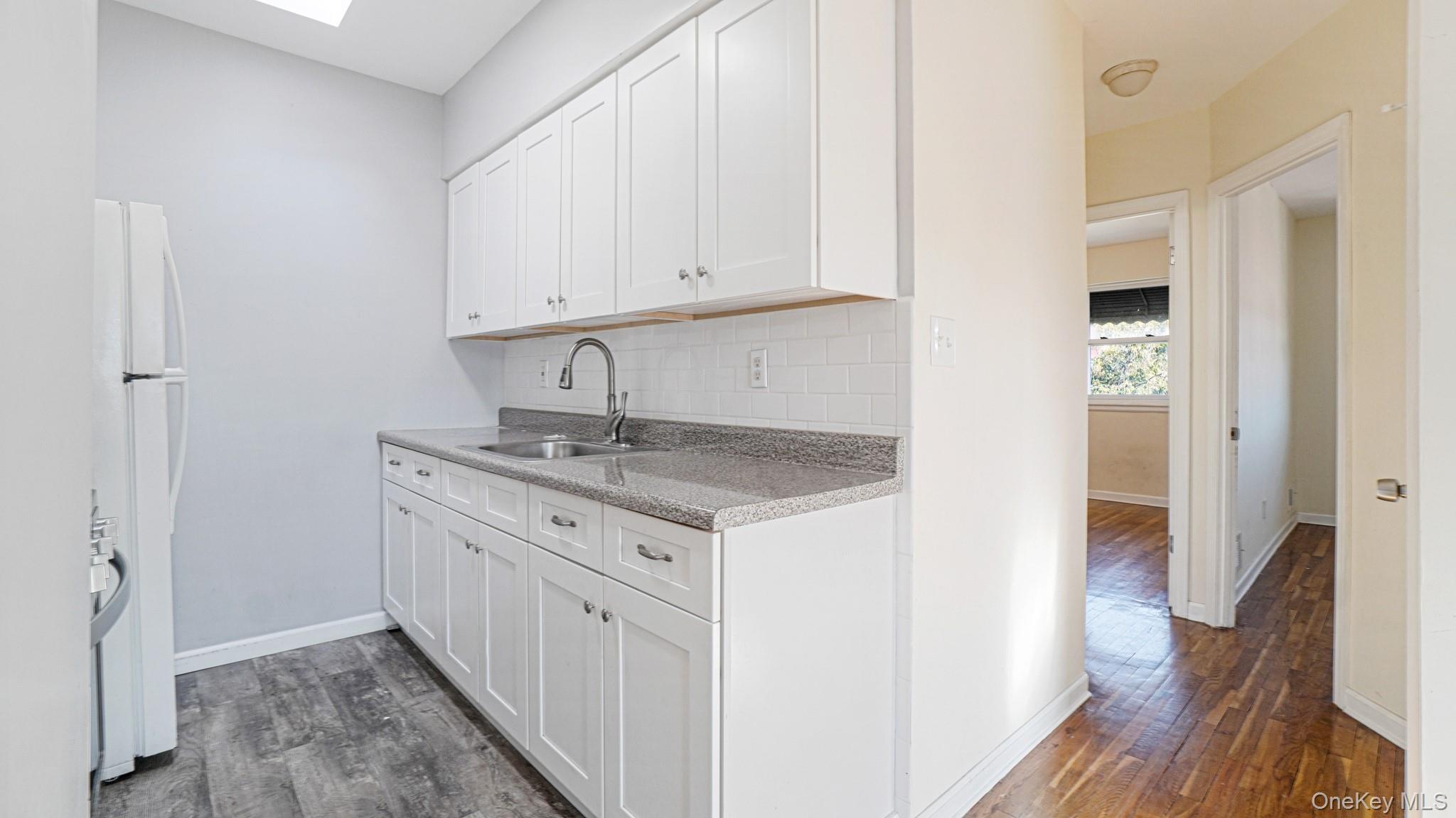 1270 Rosedale Avenue Bronx, NY 10472 - Photo 16 of 19 a kitchen with granite countertop a sink stove and cabinets