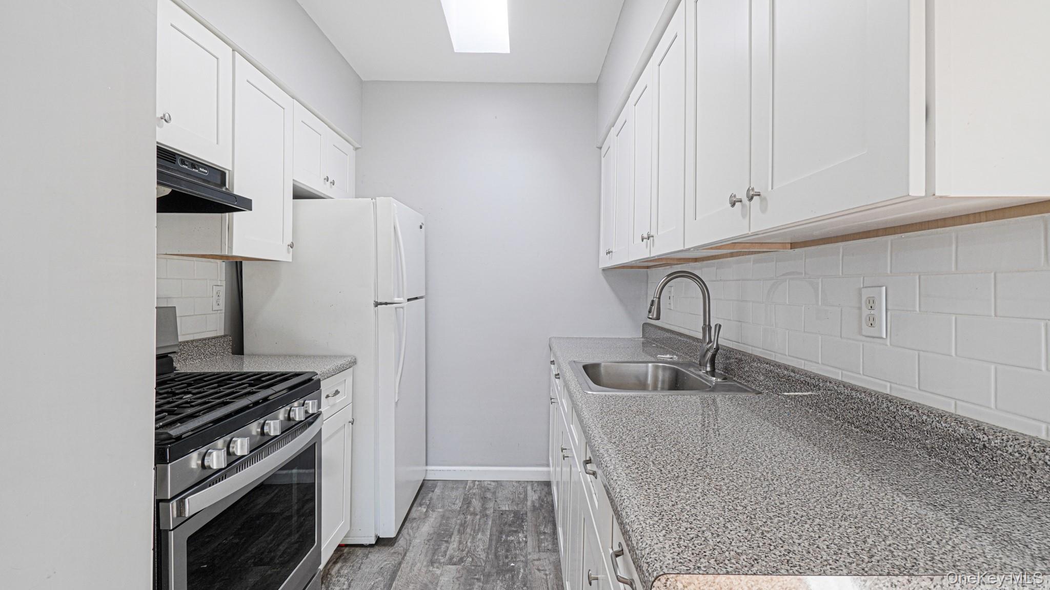 1270 Rosedale Avenue Bronx, NY 10472 - Photo 19 of 19 a kitchen with granite countertop a sink stove and refrigerator