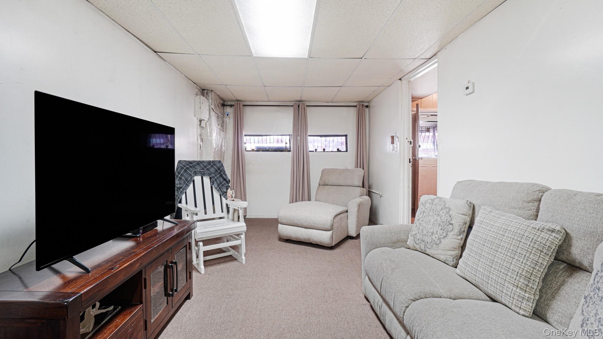 1270 Rosedale Avenue Bronx, NY 10472 - Photo 4 of 19 a living room with furniture and a flat screen tv