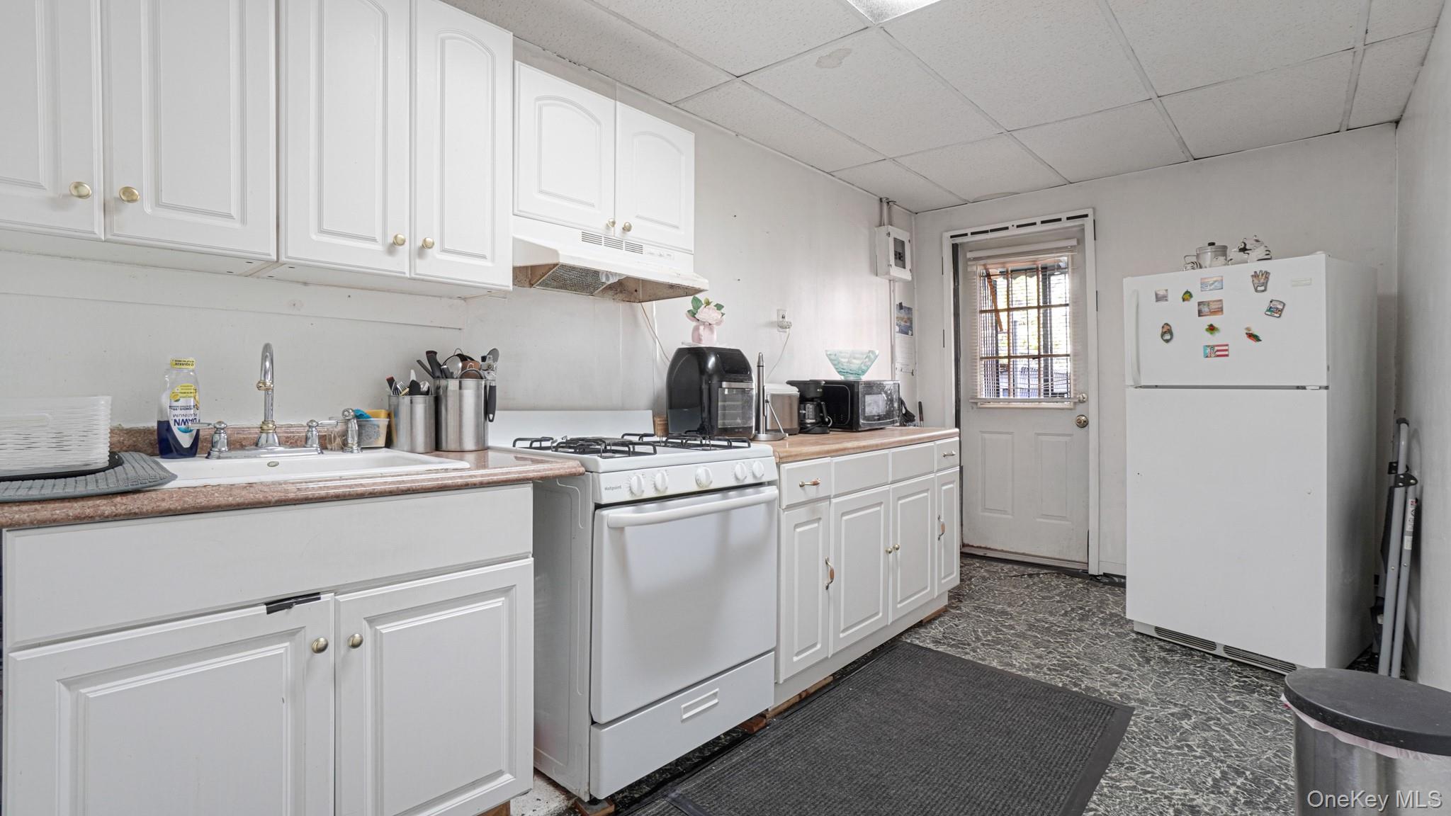 1270 Rosedale Avenue Bronx, NY 10472 - Photo 10 of 19 a kitchen with sink cabinets and window