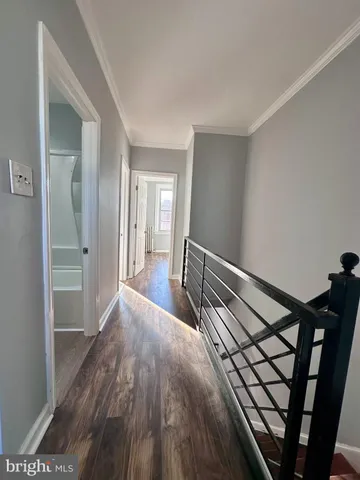 a view of hallway with wooden floor
