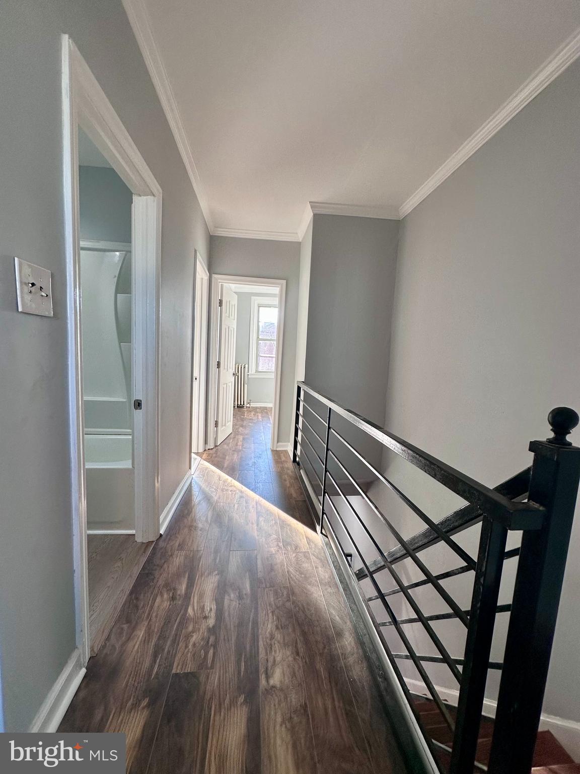 a view of hallway with wooden floor