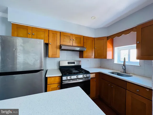 a kitchen with a sink a stove and a refrigerator