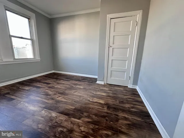 an empty room with windows and closet