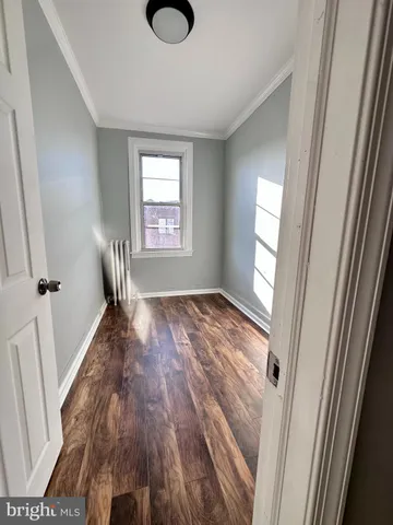 a view of a room with wooden floor and windows