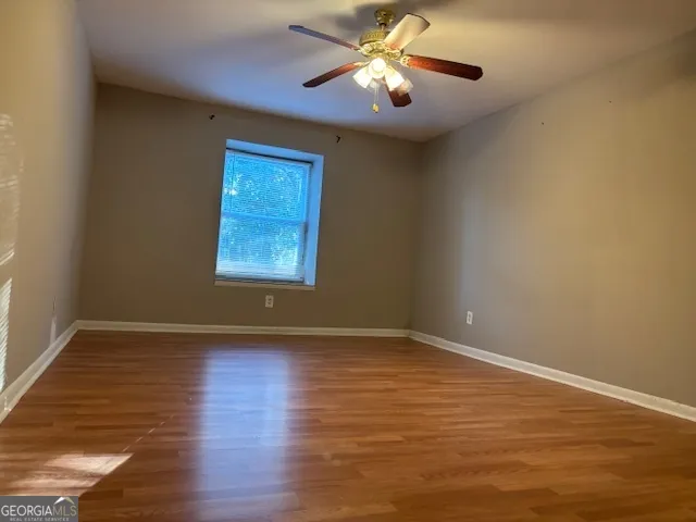 a bathroom with a granite countertop toilet and a sink