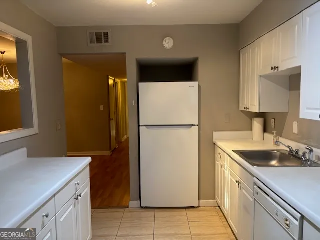 a kitchen with a sink and cabinets