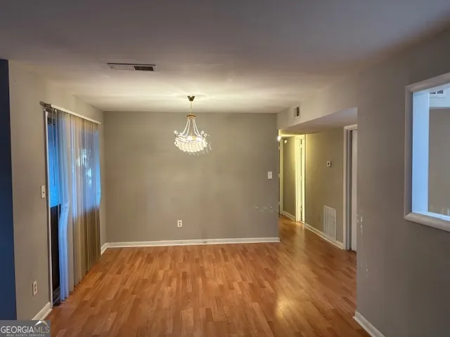 a view of a room with wooden floor and fan