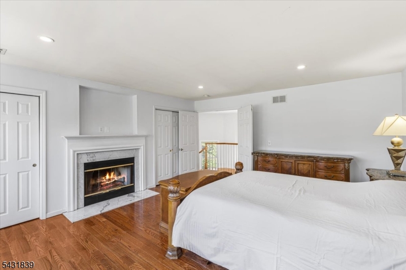 15 Spring Hunter Court Andover, NJ 07821 - Photo 29 of 49 a bedroom with a bed and a fireplace