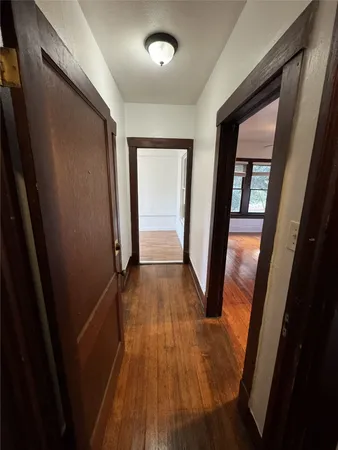 a view of gallery with wooden floor