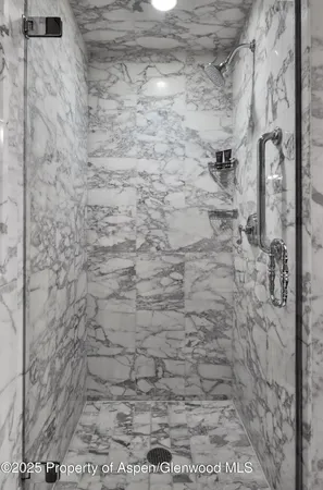 a bedroom with a bed and a flat tv screen on dresser