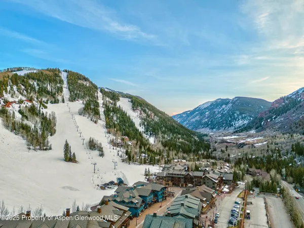 an aerial view of residential houses with outdoor space and street view