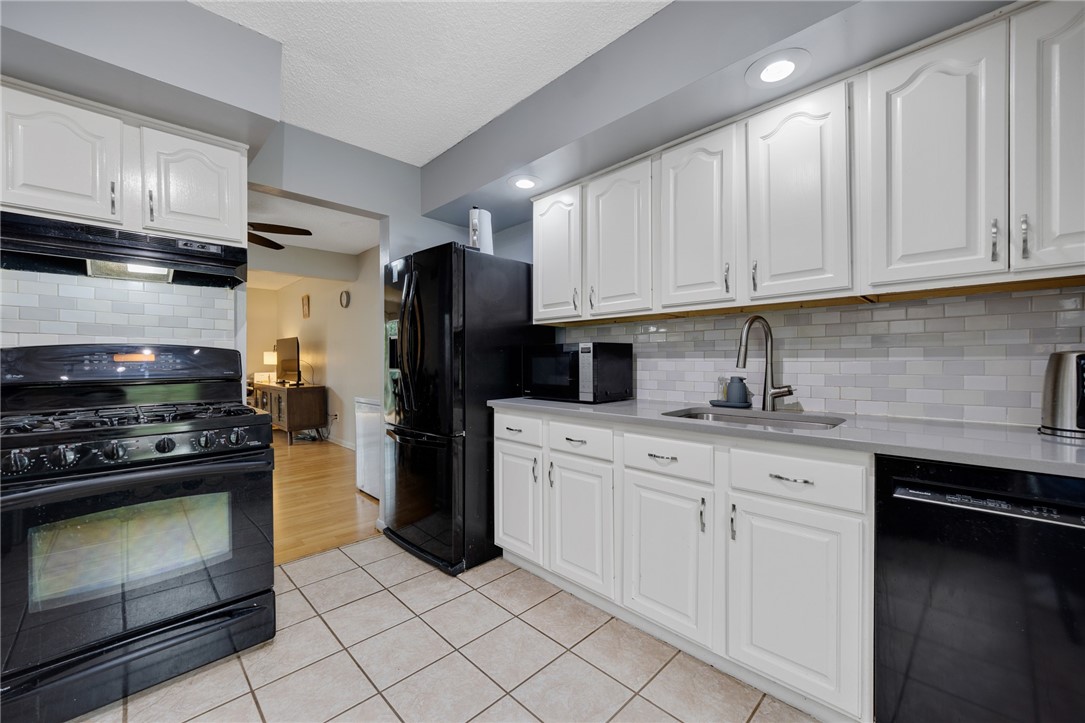 597 French Road Brighton, NY 14618 - Photo 3 of 24 Kitchen with tile floors, gas stove.