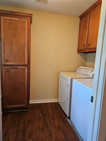 a view of a storage and utility room with a refrigerator