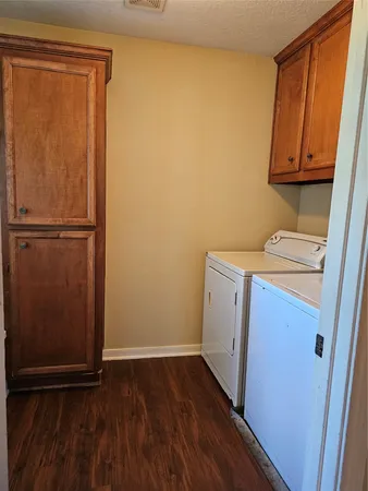 a view of a storage and utility room with a refrigerator