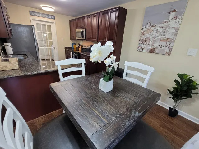 a view of kitchen with sink dining table and chairs