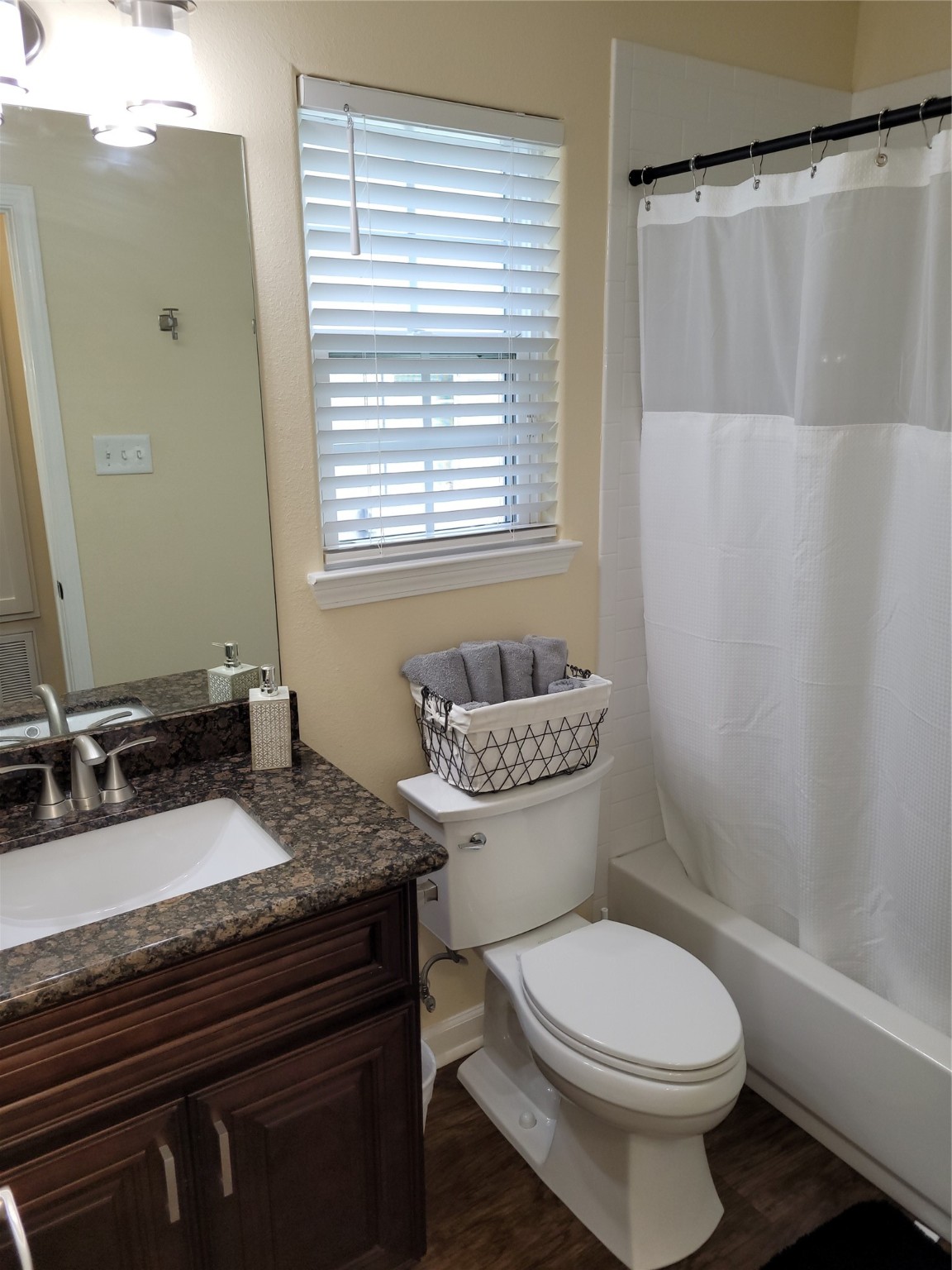 4426 25th Street East, Unit C Dickinson, TX 77539 - Photo 25 of 31 a bathroom with a granite countertop toilet a sink and a mirror
