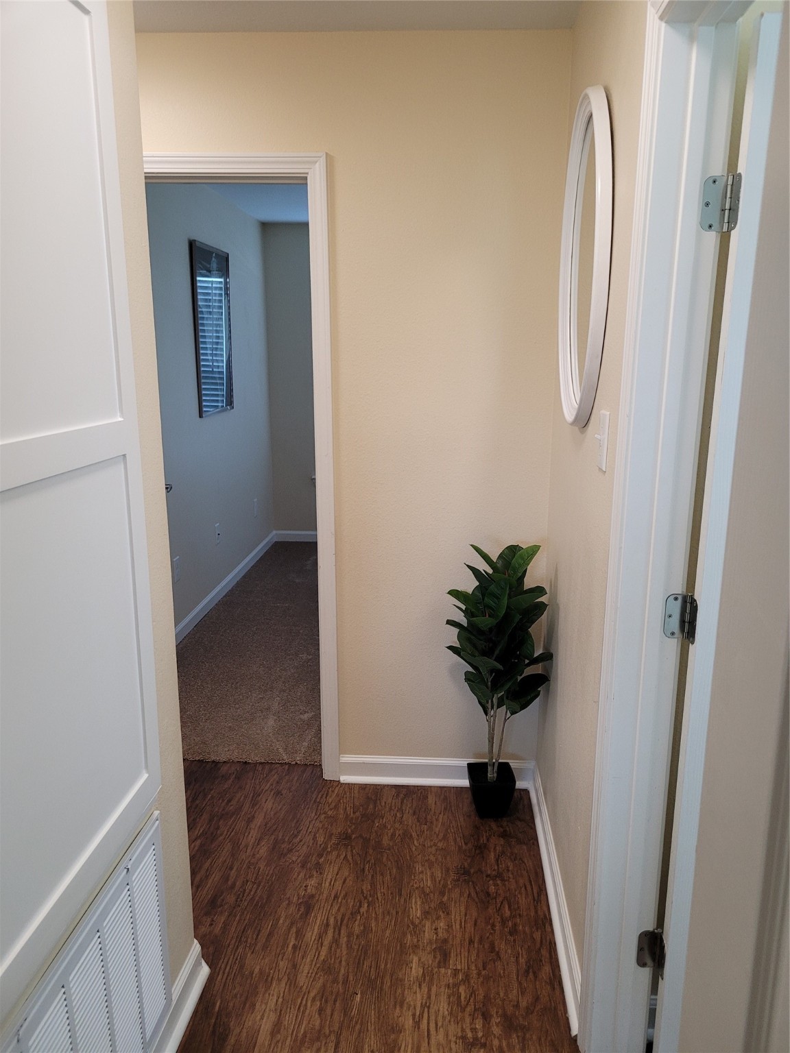 4426 25th Street East, Unit C Dickinson, TX 77539 - Photo 26 of 31 a view of a hallway with wooden floor and a chandelier