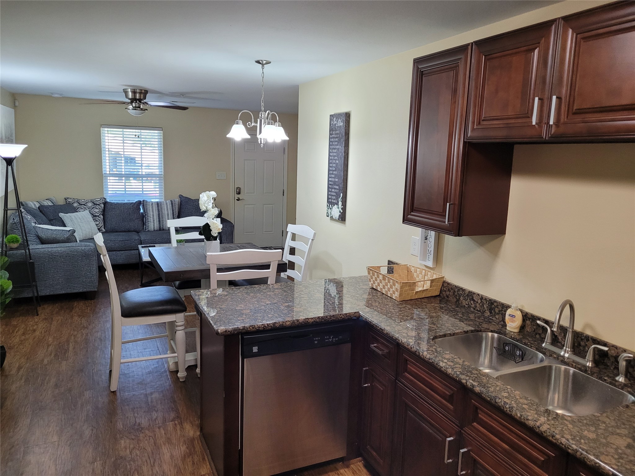 4426 25th Street East, Unit C Dickinson, TX 77539 - Photo 30 of 31 a kitchen with granite countertop a sink a stove cabinets and wooden floor