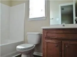 a bathroom with a sink toilet and mirror