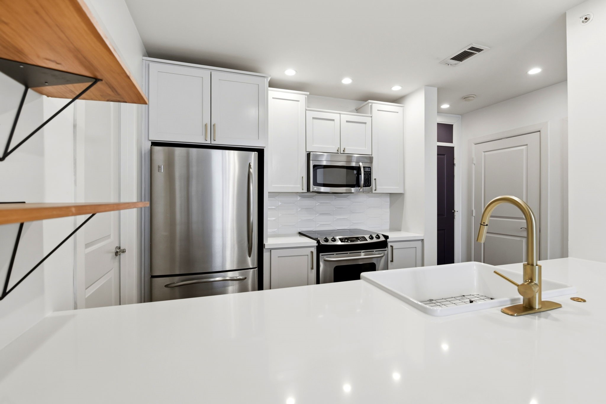1010 Rosine Street, Unit 43 Houston, TX 77019 - Photo 15 of 48 a kitchen with stainless steel appliances a refrigerator sink and stove