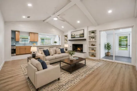 a living room with furniture and a fireplace