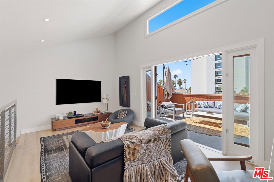 2108 Neilson Way Santa Monica, CA 90405 - Photo 25 of 70 a living room with furniture and a flat screen tv