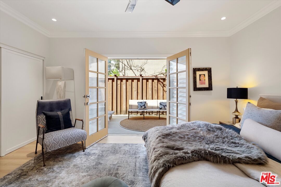 2108 Neilson Way Santa Monica, CA 90405 - Photo 34 of 70 a bedroom with a bed and glass window