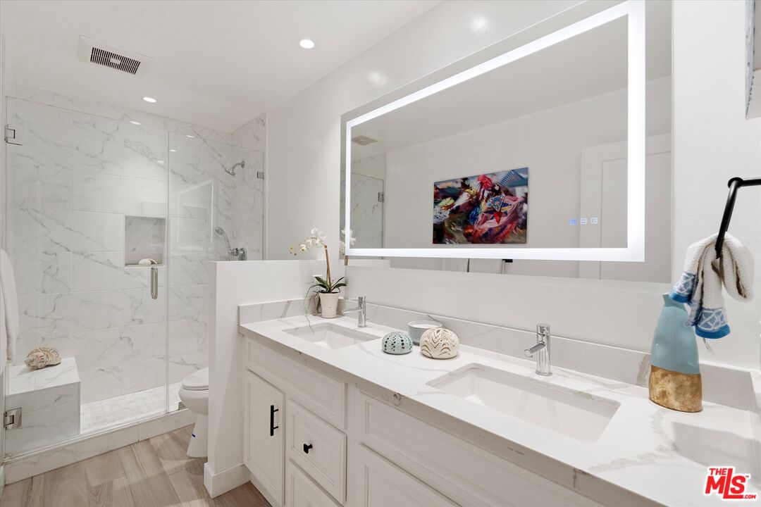 2108 Neilson Way Santa Monica, CA 90405 - Photo 42 of 70 a bathroom with a double vanity sink mirror and bathtub