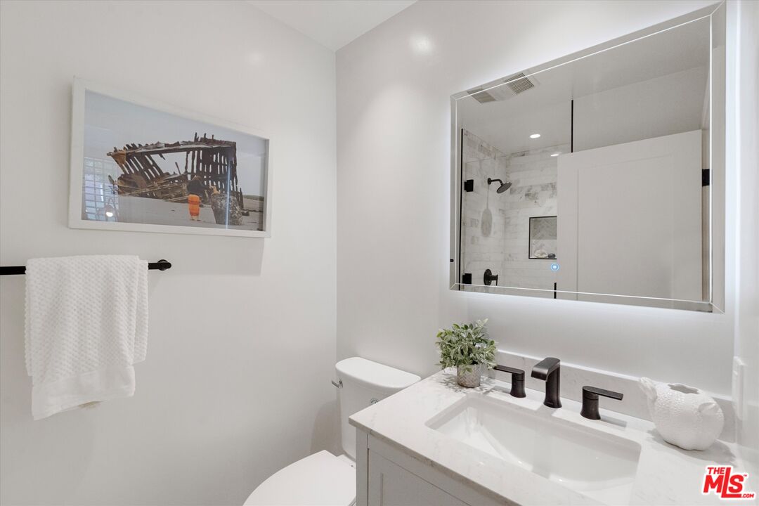 2108 Neilson Way Santa Monica, CA 90405 - Photo 46 of 70 a bathroom with a sink vanity mirror and toilet