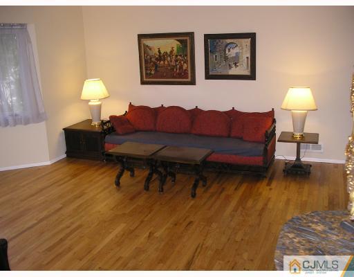 11 Amman Road Edison, NJ 08817 - Photo 2 of 10 a living room with furniture and a lamp