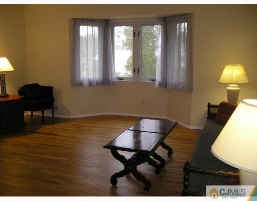 11 Amman Road Edison, NJ 08817 - Photo 3 of 10 a living room with furniture and a lamp