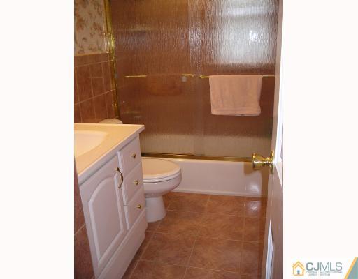 11 Amman Road Edison, NJ 08817 - Photo 5 of 10 a bathroom with a sink a toilet and shower