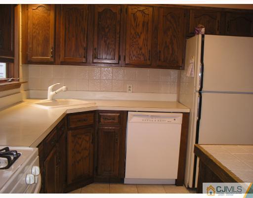 11 Amman Road Edison, NJ 08817 - Photo 7 of 10 a kitchen with a refrigerator and cabinets