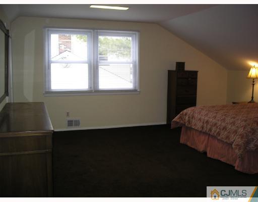 11 Amman Road Edison, NJ 08817 - Photo 8 of 10 a bedroom with a bed and a window