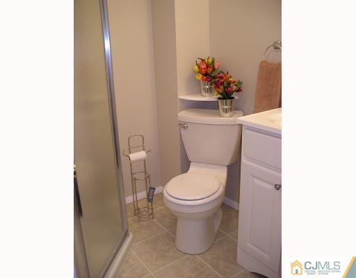 11 Amman Road Edison, NJ 08817 - Photo 9 of 10 a white toilet sitting next to a bathroom sink