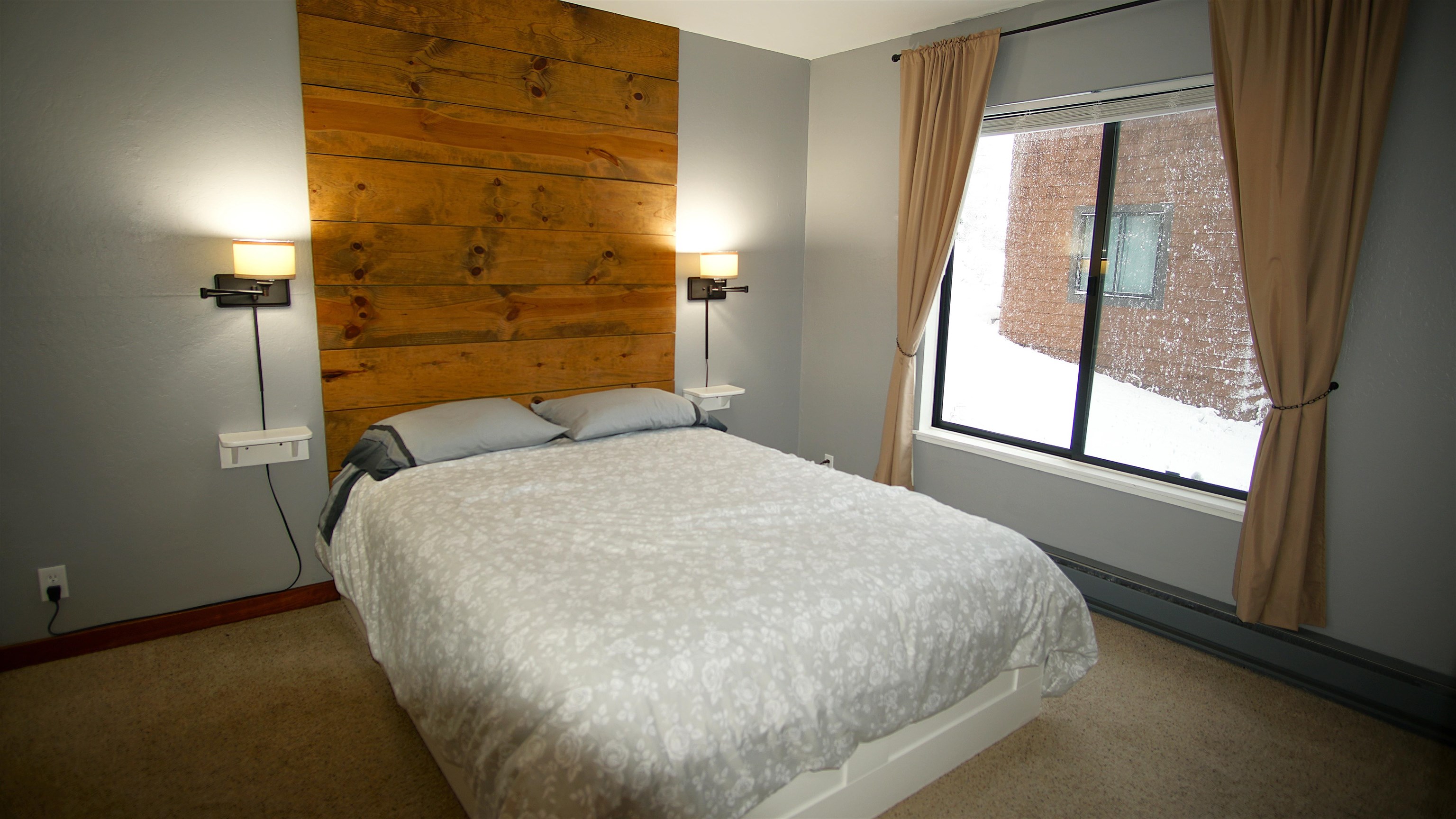 11723 Snowpeak Way, Unit 567 Truckee, CA 96161 - Photo 14 of 28 a bed sitting in a bedroom next to a window