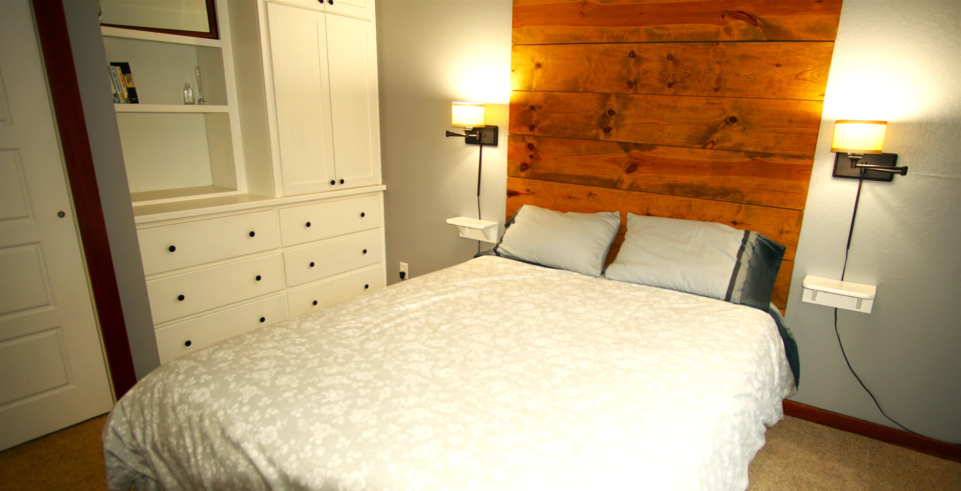 11723 Snowpeak Way, Unit 567 Truckee, CA 96161 - Photo 15 of 28 a bedroom with a bed and wooden floor